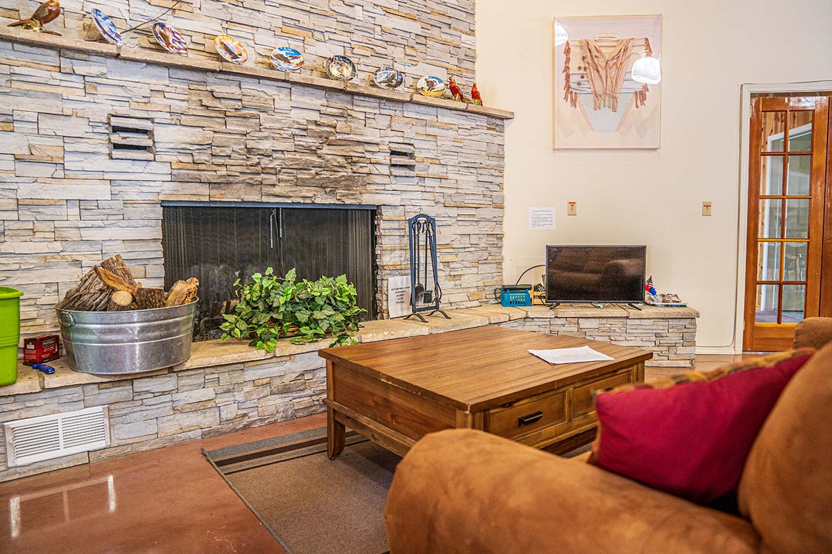 Sitting area by fireplace in Lamplighter RV Resort & Park's Clubhouse
