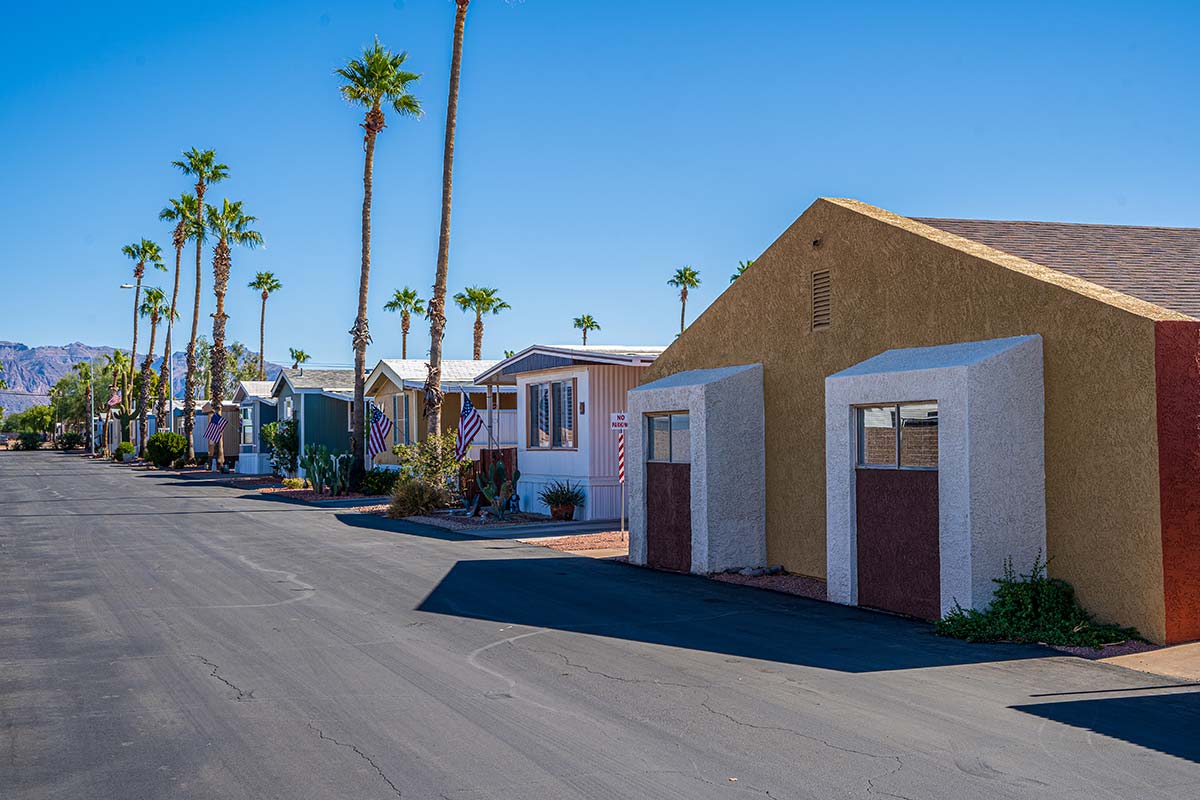 Rows of mobile homes with American flags at Sierra Leone RV Park